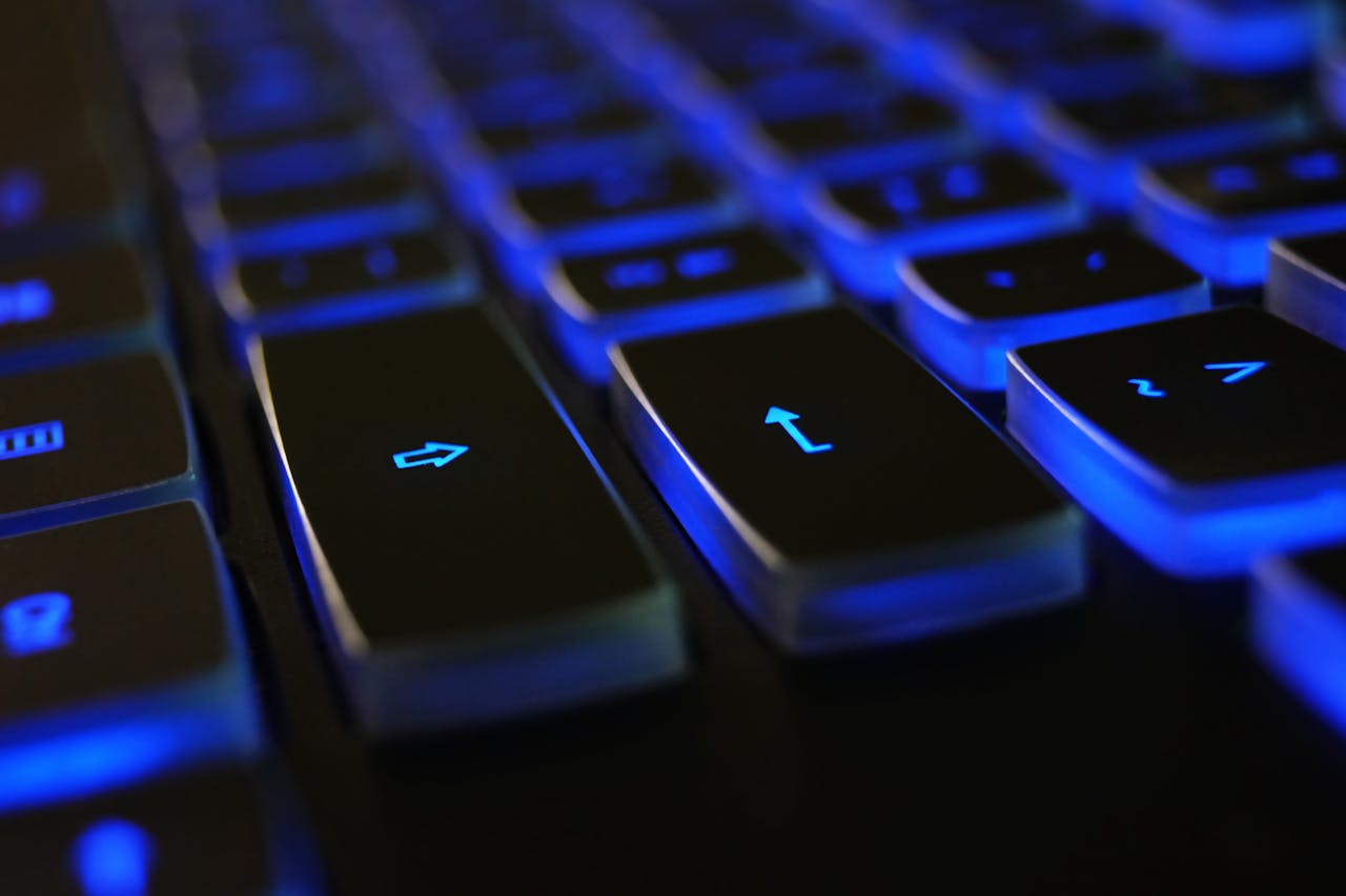 Offerings Detailed image of a computer keyboard with blue LED backlighting, highlighting keys.