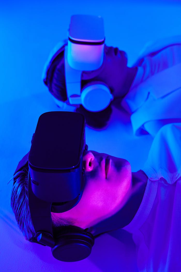 Home Close-up of people using VR headsets in vibrant studio lighting, showcasing modern technology.
